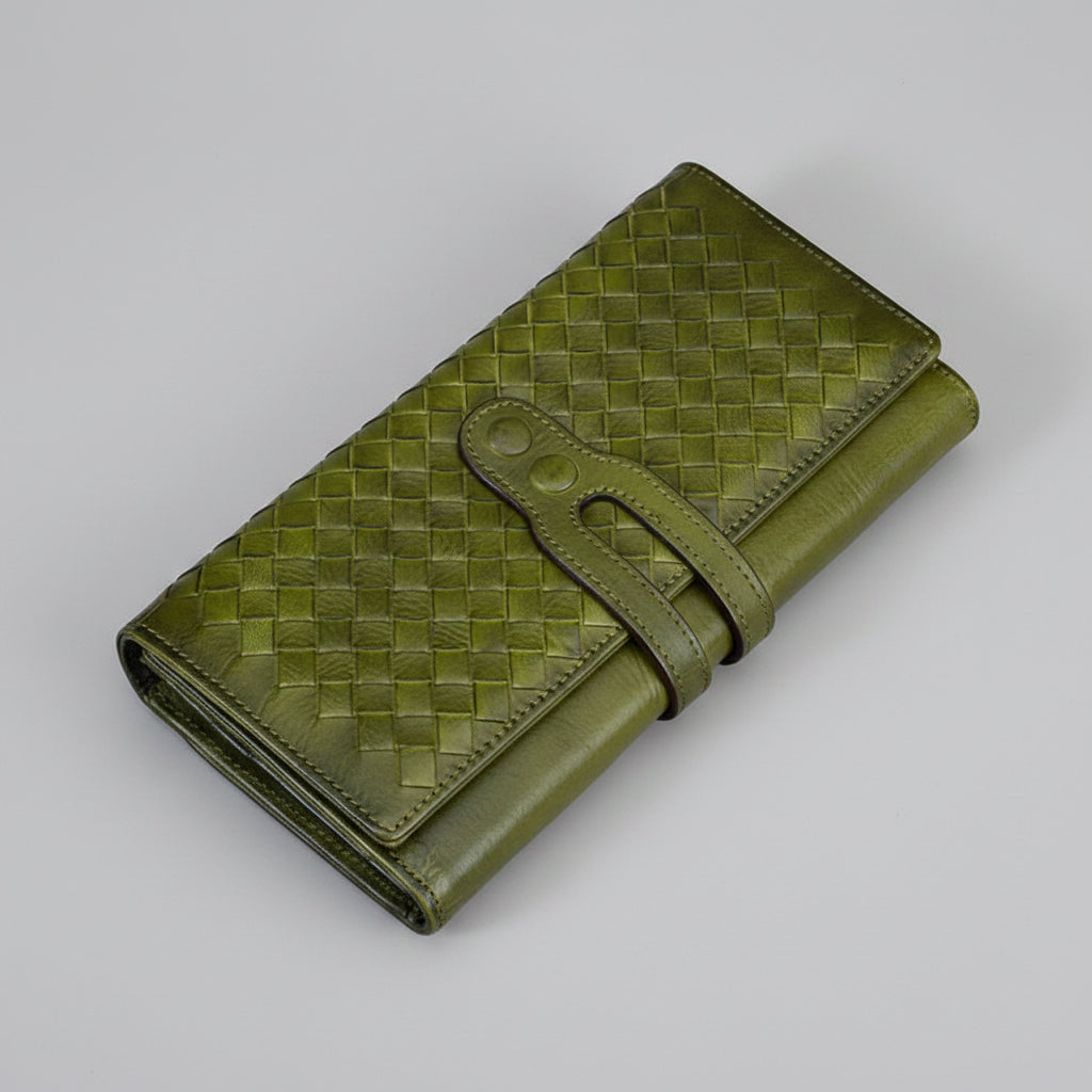 Green woven leather wallet on a gray background