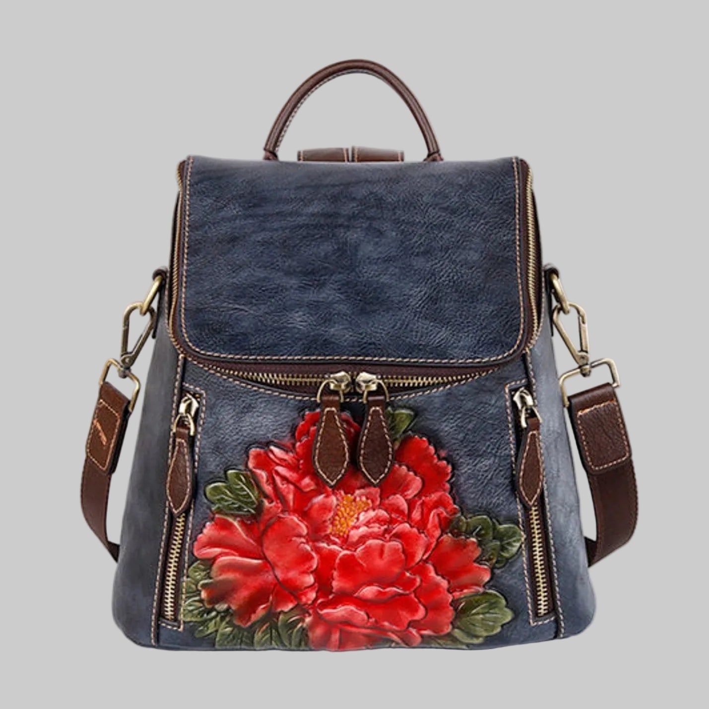 Blue denim backpack with red floral design on a white background