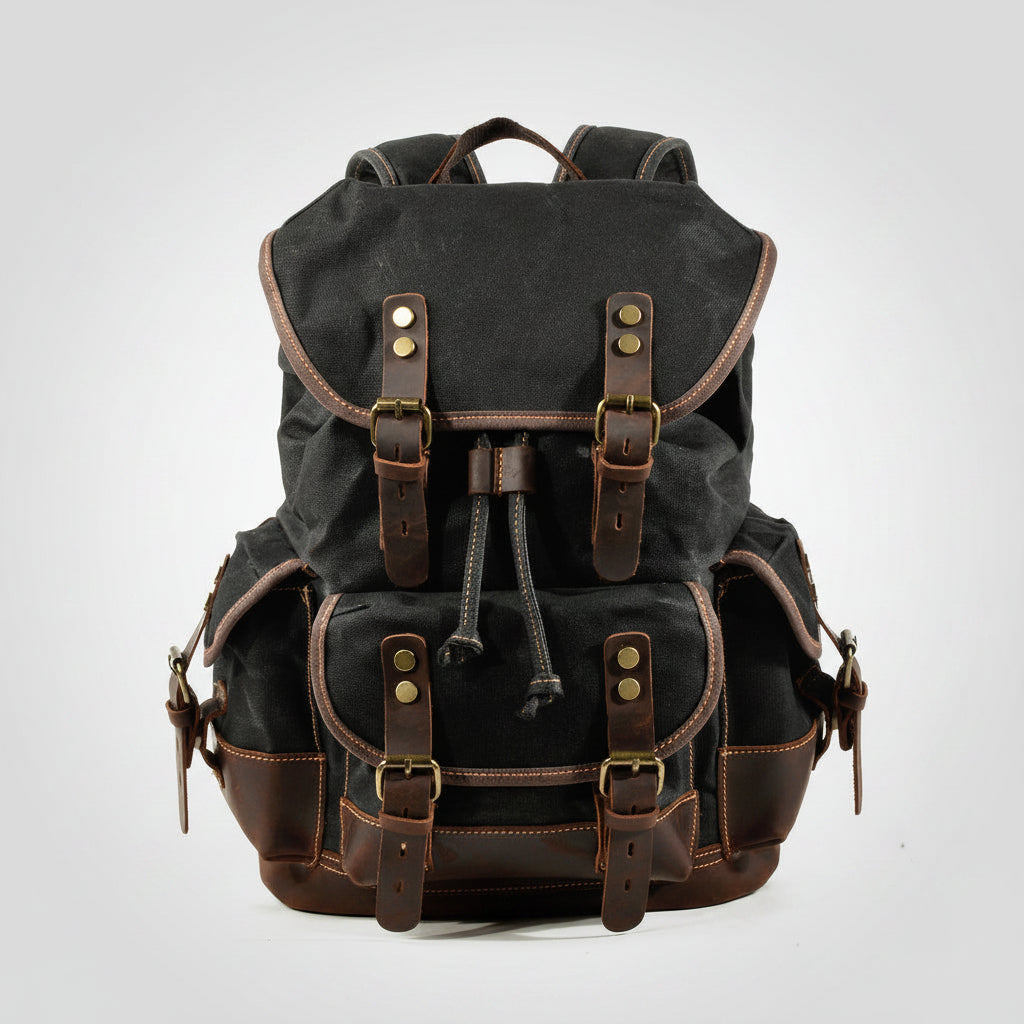 Black backpack with brown leather straps on a white background