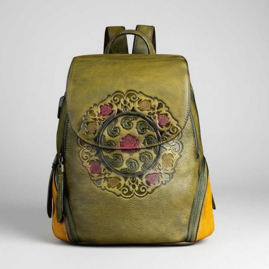 Green leather backpack with decorative emblem on a white background