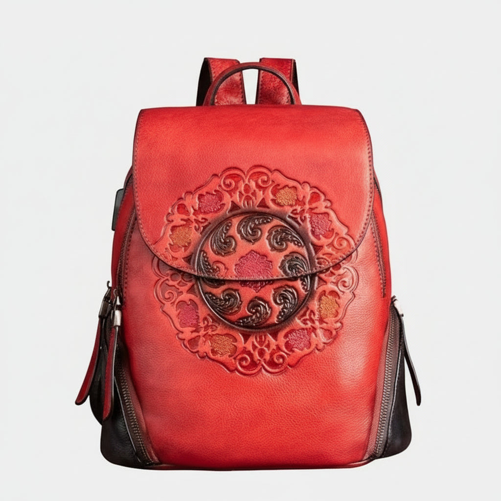 Red backpack with intricate design on a white background
