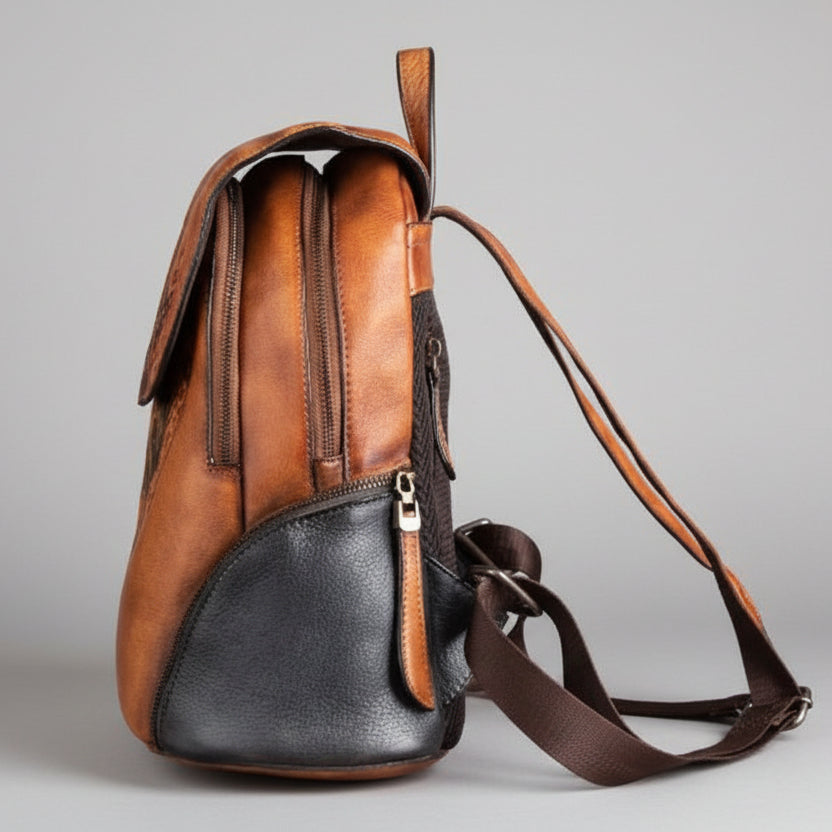 Brown and black leather backpack on a gray background
