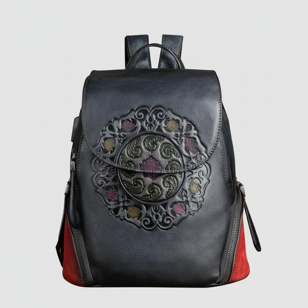 Black backpack with decorative emblem on a light gray background