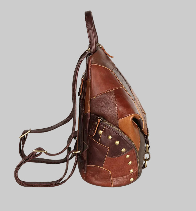 Brown leather sling bag with patchwork design on a gray background
